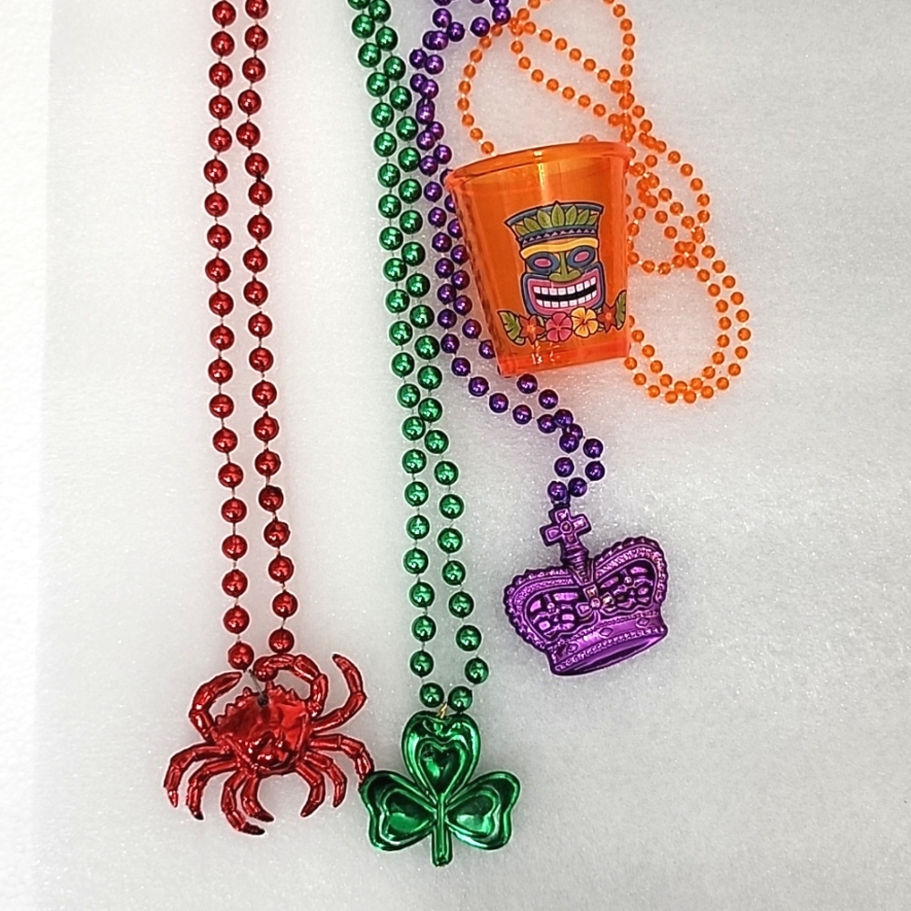 Mardi Gras Purple Crown, Green Shamrock, Red Crab,and Orange shot cup Necklaces.
